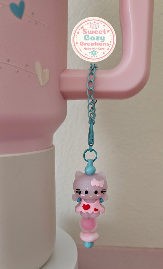 Kitty Tumbler Charm sitting on a pink bead
